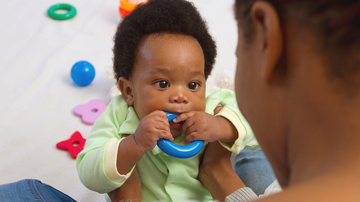 Baby-With-Teething-Ring-In-Mouth